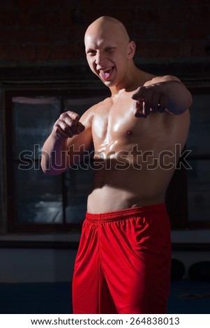 Russian boxer in red shorts laughing