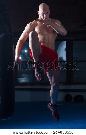 kickboxer in the gym, jump before impact