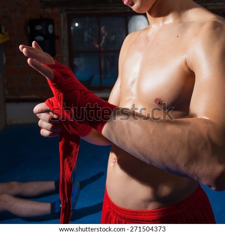 kickboxer wraps his hands red bandages
