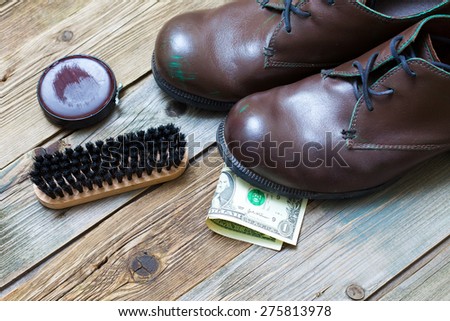 boots, brush, shoe polish and dollar. service. Shoe Shine for money