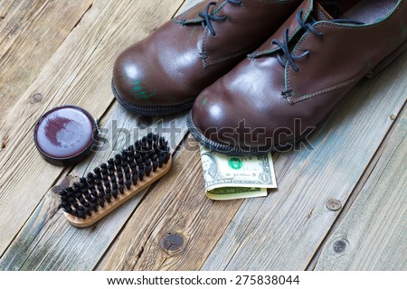 service. Shoe Shine for money. boots, brush, shoe polish and dollar