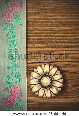 still life, vintage aqua color tape with embroidered ornaments and old button flower. instagram image filter retro style