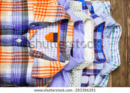 shirts in pile on old textured wood boards