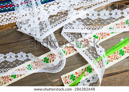 vintage ribbons, tape and lace on old surface of tailorÃ¢??s table