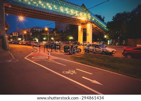 Moscow, Russia, June 14, 2015: Landscape near Frunze Embankment with motorcycles, cars and bike path under the Andreevsky bridge at summer night. instagram image filter retro style
