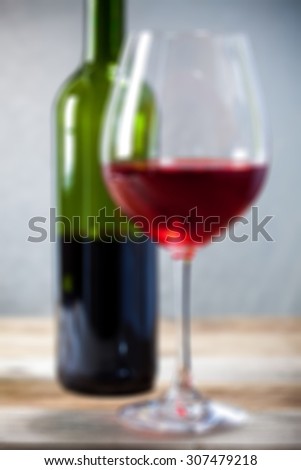 bad red wine in goblet and green bottle. romantic blur still life