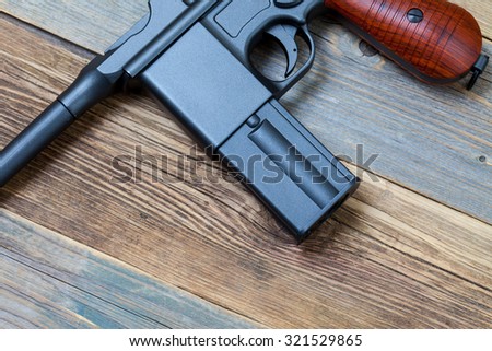 mauser pistol gun on old boards, part of
