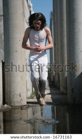 man in white cloth and with long hair levitation above water
