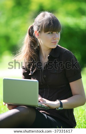 woman in the black dress with laptop on open air