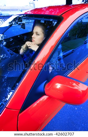 young woman in red car dreams of future