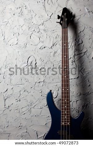 guitar stands near the gray wall