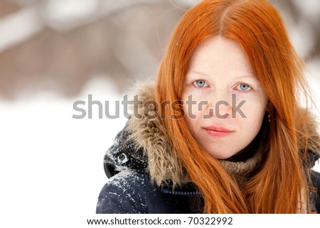 young redhead woman in the winter park