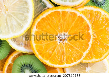 Collection of fruits slices. Orange, lemon and kiwi closeup. Healthy food background