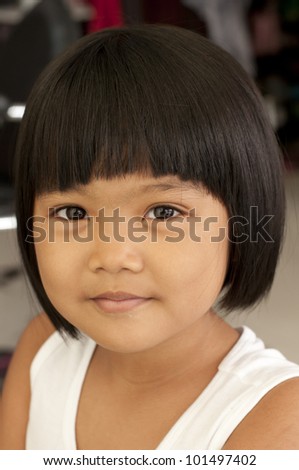 Portrait of a little Asian girl in smiling act