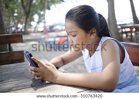Young lady to looking mobile phone at outdoor location