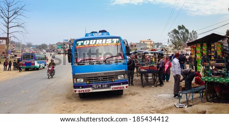 Lamahi, Nepal - 5 February 2014: A long-distance bus headed for Nepalgunj takes a rest break in Lamahi bus park in the Terai region