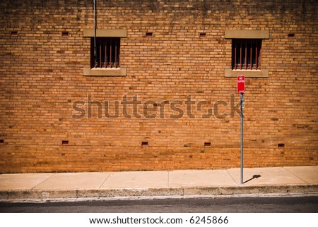 Brick wall and No Stopping sign in back street - ideal grunge background