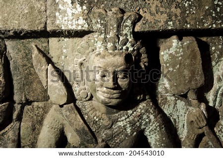 sculpture of a warrior in angkor wat, cambodia