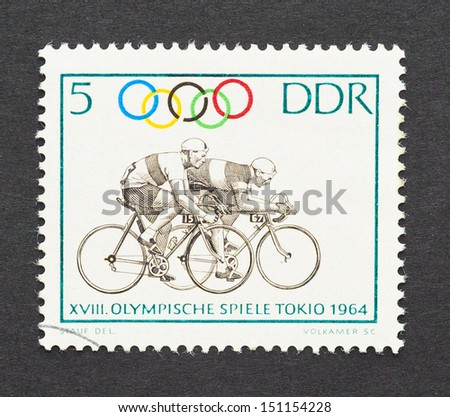GERMAN DEMOCRATIC REPUBLIC - CIRCA 1964: a postage stamp printed in DDR showing an image of cyclists in Tokyo 1964 olympics, circa 1964.