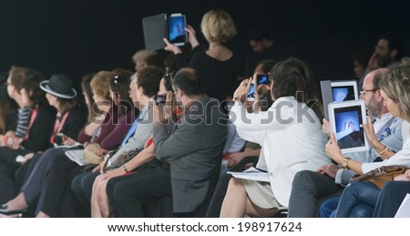 BARCELONA - MAY 08: the audience takes pictures and records on Cymbeline bridal collection 2015 catwalk during the Barcelona Bridal Week runway on May 08, 2014 in Barcelona, Spain.