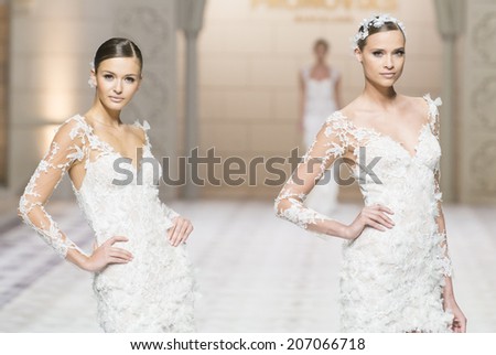 BARCELONA - MAY 09: models walking on the Pronovias bridal collection 2015 catwalk during the Barcelona Bridal Week runway on May 09, 2014 in Barcelona, Spain.
