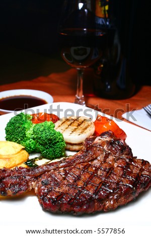 grilled t-bone steak with grilled veggies and red wine