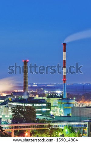 Industrial chimneys smoking at night. Long exposure.
