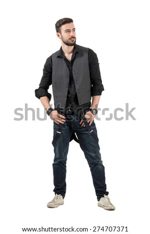 Young trendy fashion male model looking at distance. Full body length portrait isolated over white background.