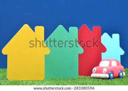 Colorful arrangement of mini house made from cardboard and car toy