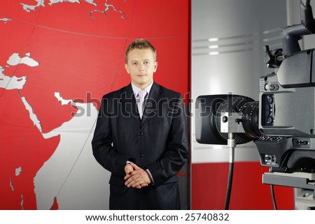 blond middle age news presenter in studio in front of the camera with braking news reports