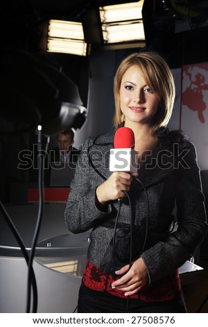 smiling television news reporter in live transmission with braking news in studio
