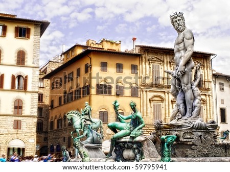 Neptune Statue in Florence, Italy with classic Italian architecture in the back.