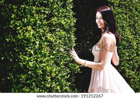 young girl model in pink dress on the nature