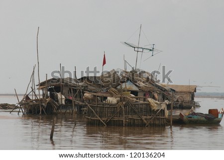 A jumble of fish nets and fish pots identify the floating home of a fisherman on the Mekong River of Vietnam