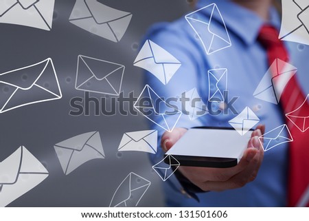Business woman holding smartphone sending mail - with copy space on the phone