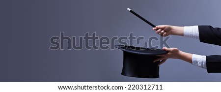 Magician hands with hat and magic wand - with copy space