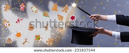 Christmas magic with gingerbread cookies - magician hands holding black hat and wand