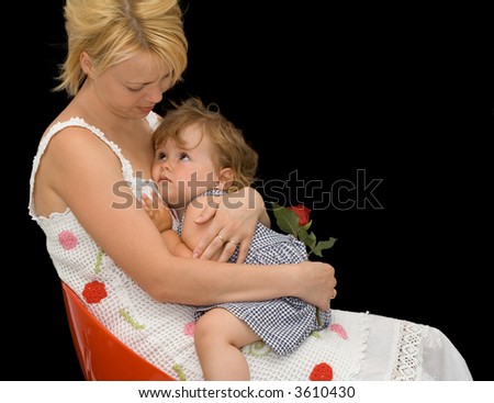 Mother comforting her daughter - concept for parenthood and childhood - isolated on black