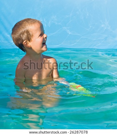 Little boy in the cool water yard pool