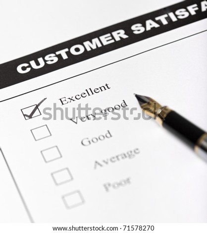 Customer satisfaction survey form with pen - closeup with focus on the checked excellent checkbox