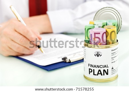 Business man making financial plans with an opened can of euro banknotes - closeup