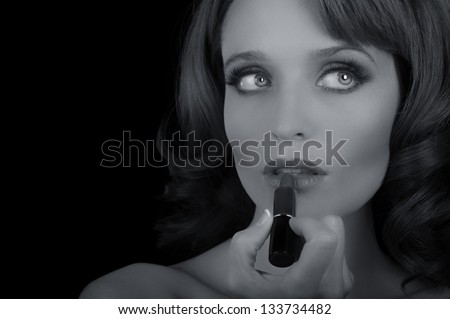 Beautiful Image of a Woman Putting On Lipstick