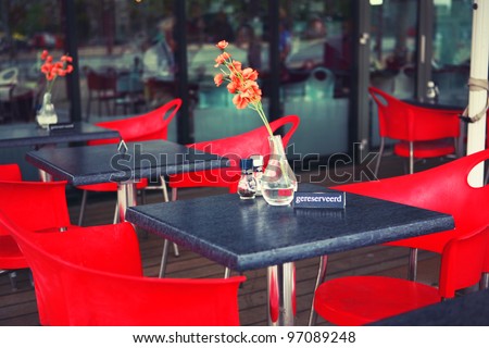 Reserved table sign with fresh flowers outside restaurant in Amsterdam, the Netherlands