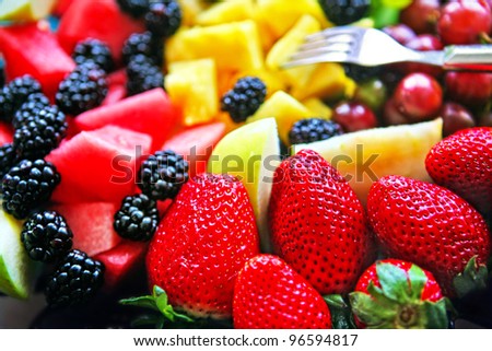 Mixed Fruit platter with fork strawberries blackberries pineapple and watermelon ストックフォト © 