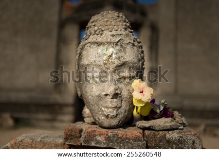 Far west of Thailand, there is a temple flooded by the water. It stays under the water almost all year. When water level is low. The remaining of this Buddha statue shows up remaining only it\'s head.