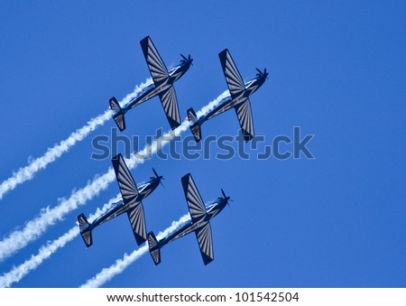 PRETORIA, SOUTH AFRICA -14 AUG 2010 - A tight 4 ship formation of silver falcons with smoke generators at SAAF 90 airshow on 14 August 2010 from Air Force base Swartkop.