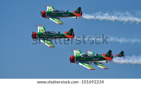 PRETORIA, SOUTH AFRICA - 14 AUG 2010 - A tight 4 ship formation of Harvards in green and red color scheme during the SAAF 90 airshow on 14 August 2010 at Swartkop Airforce Base
