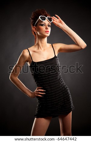 Sexy rock\'n\'roll girl in black dress and white glasses;