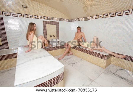 Relaxation in hamam, three young people in turkish sauna