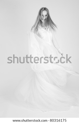 Monochrome shot of dancing girl with long skirt, studio shot